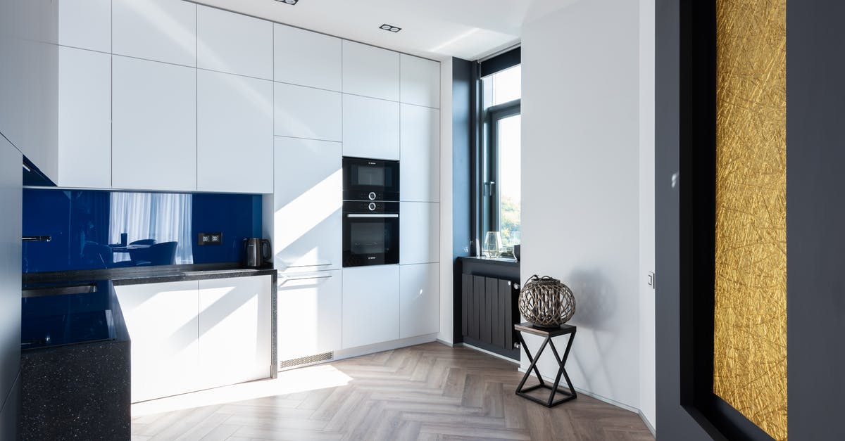 How can I clean my oven window? - Interior of contemporary light kitchen with white cupboards and oven placed near window and decorations in room with modern decorations How can I clean my oven window? - Interior of contemporary light kitchen with white cupboards and oven placed near window and decorations in room with modern decorations