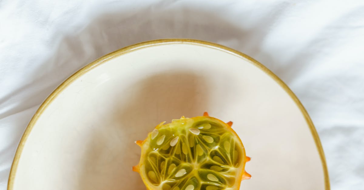 How can I concentrate citrus juice at home? - Top view of fresh kiwano on white plate on fabric in light room How can I concentrate citrus juice at home? - Top view of fresh kiwano on white plate on fabric in light room