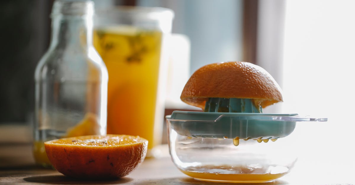 How can I concentrate citrus juice at home? - Half of delicious sweet orange placed on plastic orange juicer placed on kitchen table How can I concentrate citrus juice at home? - Half of delicious sweet orange placed on plastic orange juicer placed on kitchen table