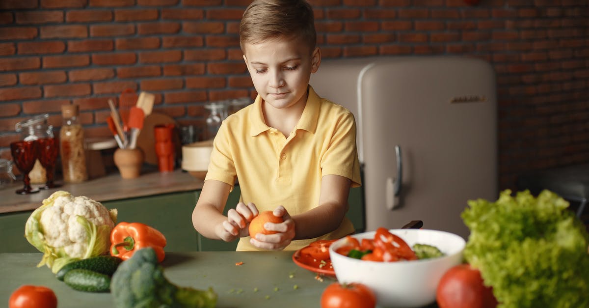 How can I concentrate citrus juice at home? - Confident kid peeling fresh orange sitting at table with assorted vegetables and fruits near salad bowl during vegetarian meal preparation in loft kitchen with brick walls How can I concentrate citrus juice at home? - Confident kid peeling fresh orange sitting at table with assorted vegetables and fruits near salad bowl during vegetarian meal preparation in loft kitchen with brick walls