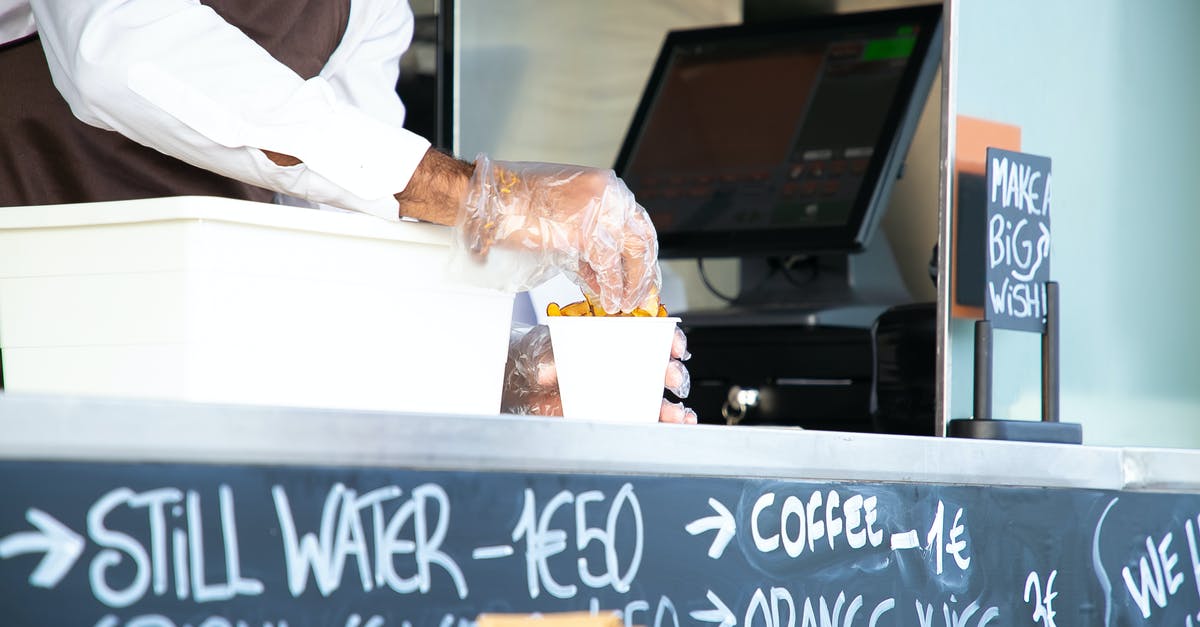 How can I cook 1/2 a cup of rice? - Low angle of crop anonymous male seller with cup of fried food at counter with cashier How can I cook 1/2 a cup of rice? - Low angle of crop anonymous male seller with cup of fried food at counter with cashier