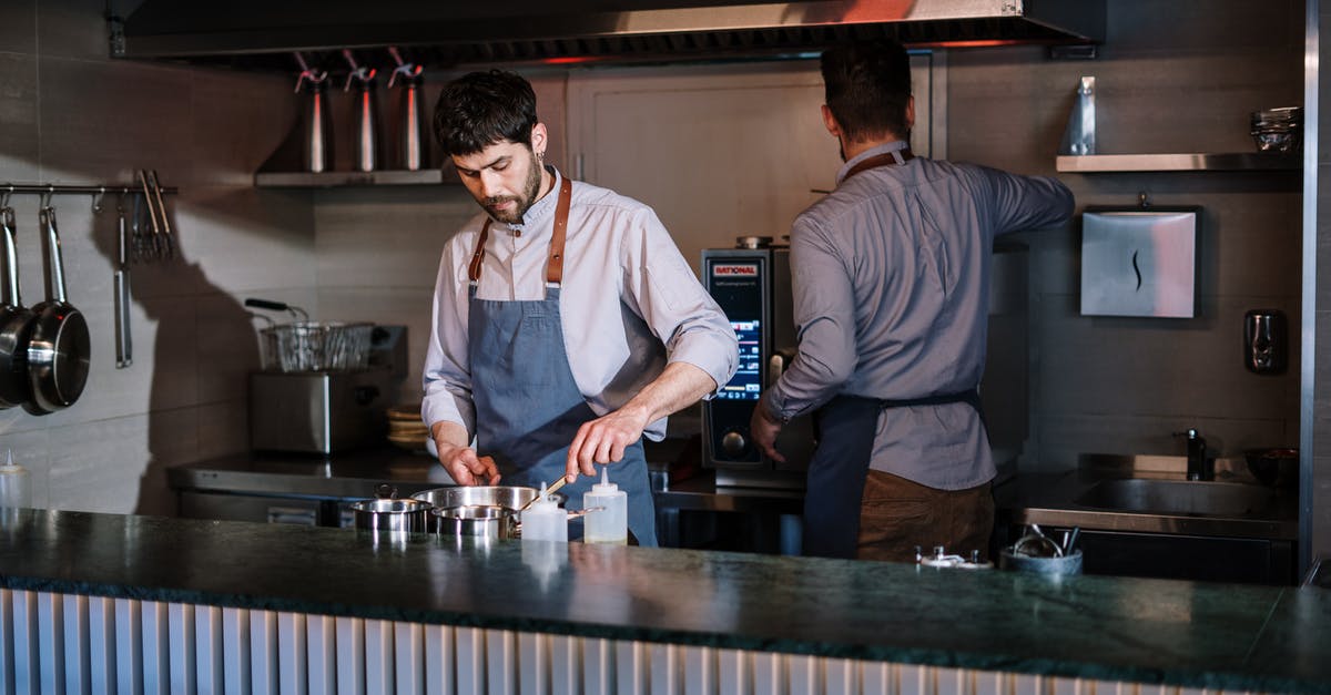 How can I cook a perfect deep-fried Mars bar? - Man in White Dress Shirt Standing Beside Man in Black Vest How can I cook a perfect deep-fried Mars bar? - Man in White Dress Shirt Standing Beside Man in Black Vest