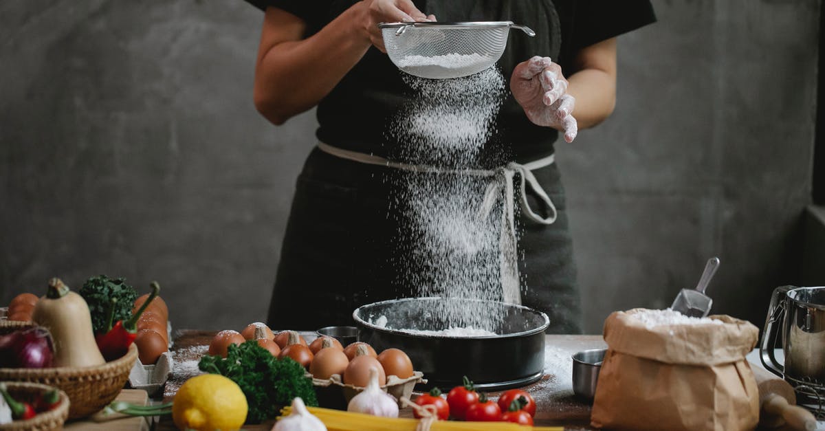 How can I cook cod without lemons? - Crop unrecognizable cook adding flour into stainless baking dish while cooking meal with spaghetti cherry tomatoes garlic herbs and lemon