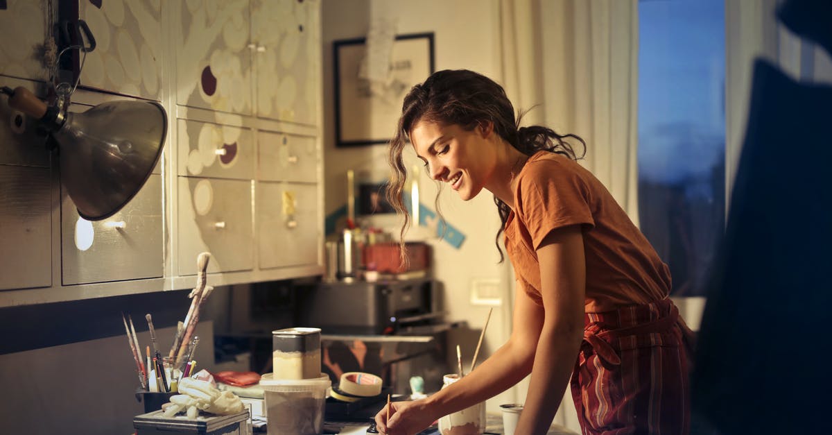 How can i create a crunchy exterior with and airy interior donut? - Photo of Woman Painting While Smiling and Standing by the Table