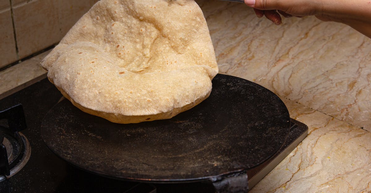 How can I create steam in a normal oven to promote bread oven spring? - Person Holding Stainless Steel Bread Knife How can I create steam in a normal oven to promote bread oven spring? - Person Holding Stainless Steel Bread Knife