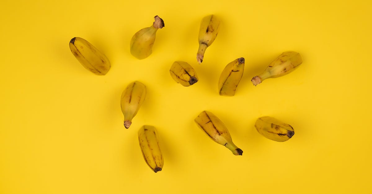 How can I cut fudge smooth and uniform? - Overhead view of delicious ripe banana halves with stems and blots on peel on yellow background How can I cut fudge smooth and uniform? - Overhead view of delicious ripe banana halves with stems and blots on peel on yellow background