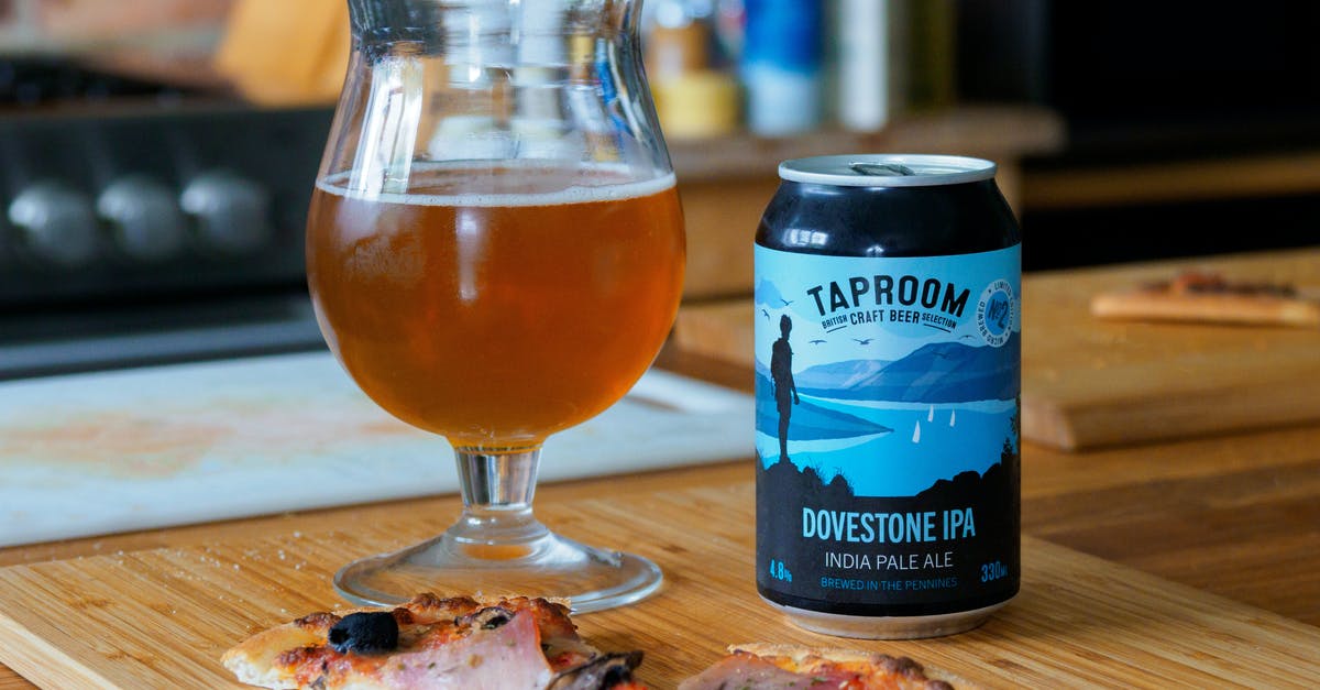 How can I ensure that my pizza is properly cooked? - Blue and White Labeled Pack Beside Clear Drinking Glass on Brown Wooden Table How can I ensure that my pizza is properly cooked? - Blue and White Labeled Pack Beside Clear Drinking Glass on Brown Wooden Table