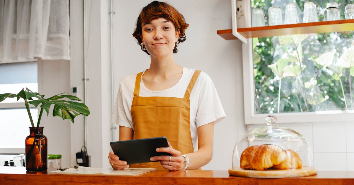 How can I fix rips in a puff pastry sheet? - Sincere young female cafeteria worker with tablet looking at camera near container with tasty pastries How can I fix rips in a puff pastry sheet? - Sincere young female cafeteria worker with tablet looking at camera near container with tasty pastries