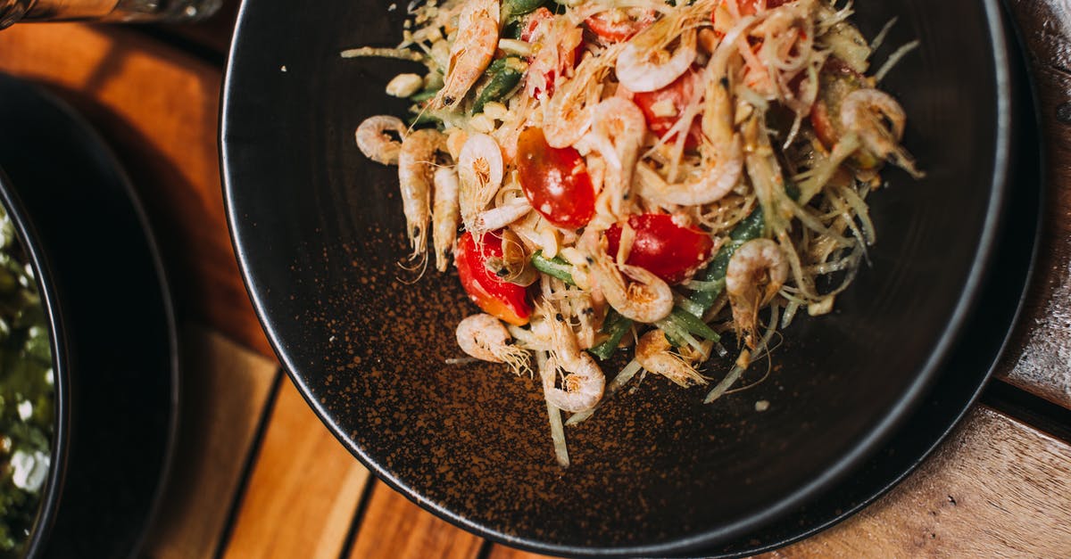How can I improve a dish with badly cooked spices without recooking? [closed] - Cooked Shrimp Dish on Black Ceramic Bowl