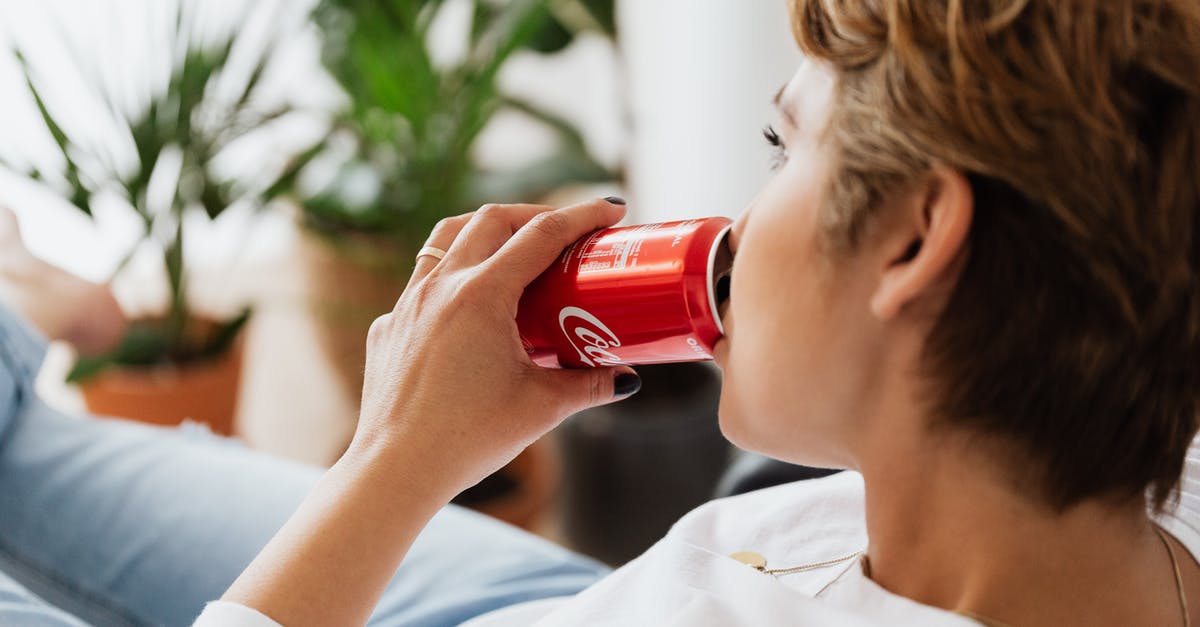 How can I keep my burgers flat? - Crop unrecognizable thoughtful female enjoying coke while resting at home