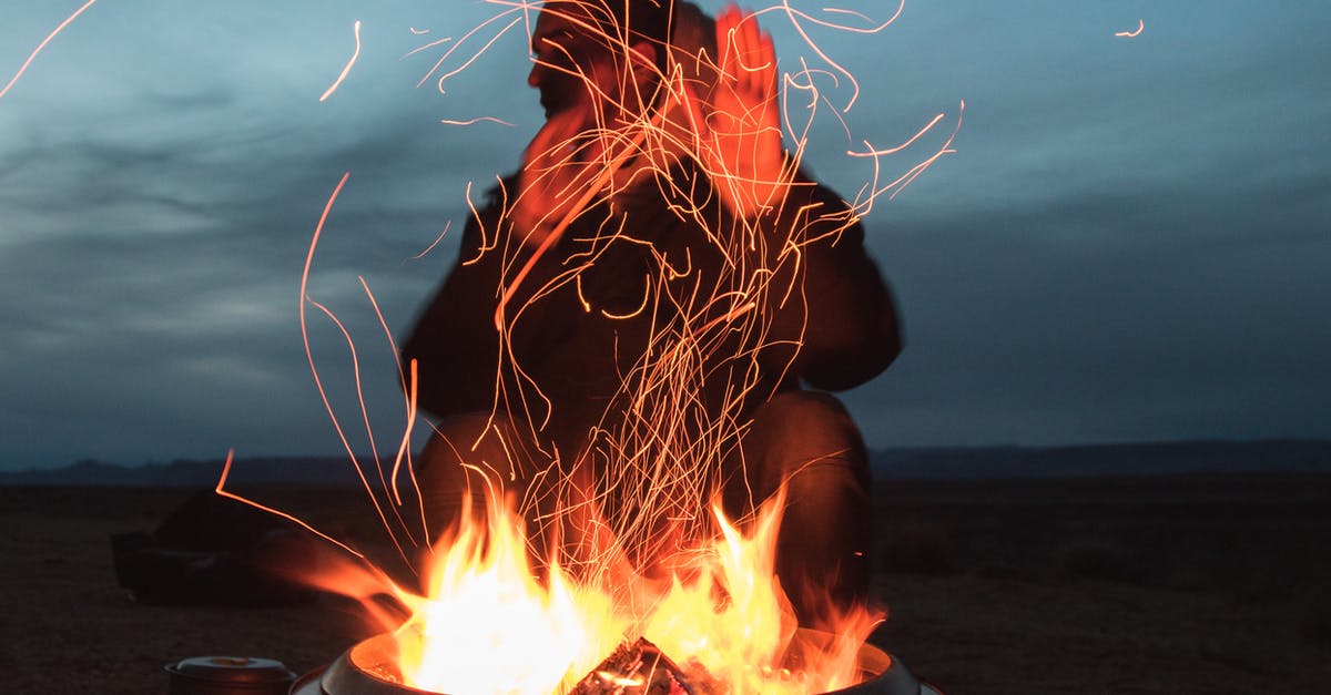 How can I light charcoal faster? - Man Sitting Facing Fire in Pot during Night How can I light charcoal faster? - Man Sitting Facing Fire in Pot during Night