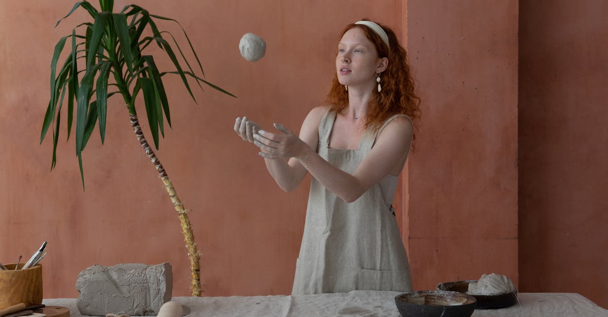How can I make a soft Turkish bread? - Young skilled female ceramist wearing light apron throwing clay ball while making ceramic products in modern workshop How can I make a soft Turkish bread? - Young skilled female ceramist wearing light apron throwing clay ball while making ceramic products in modern workshop