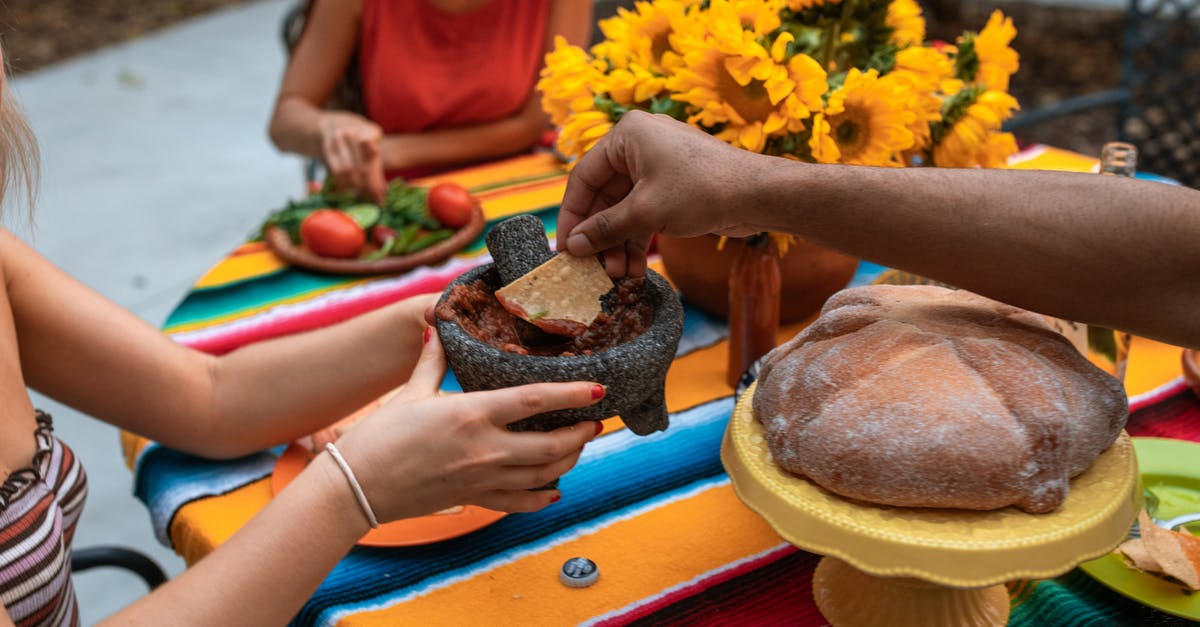 How can I make crispy chips? - Crop unrecognizable people eating meat stew and nachos