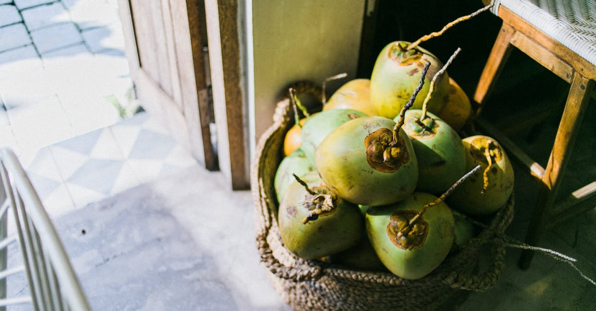 How can I make dry coconut from fresh coconut meat? - From above of young light green coconuts in fabric basket next to old wooden stool in daytime How can I make dry coconut from fresh coconut meat? - From above of young light green coconuts in fabric basket next to old wooden stool in daytime
