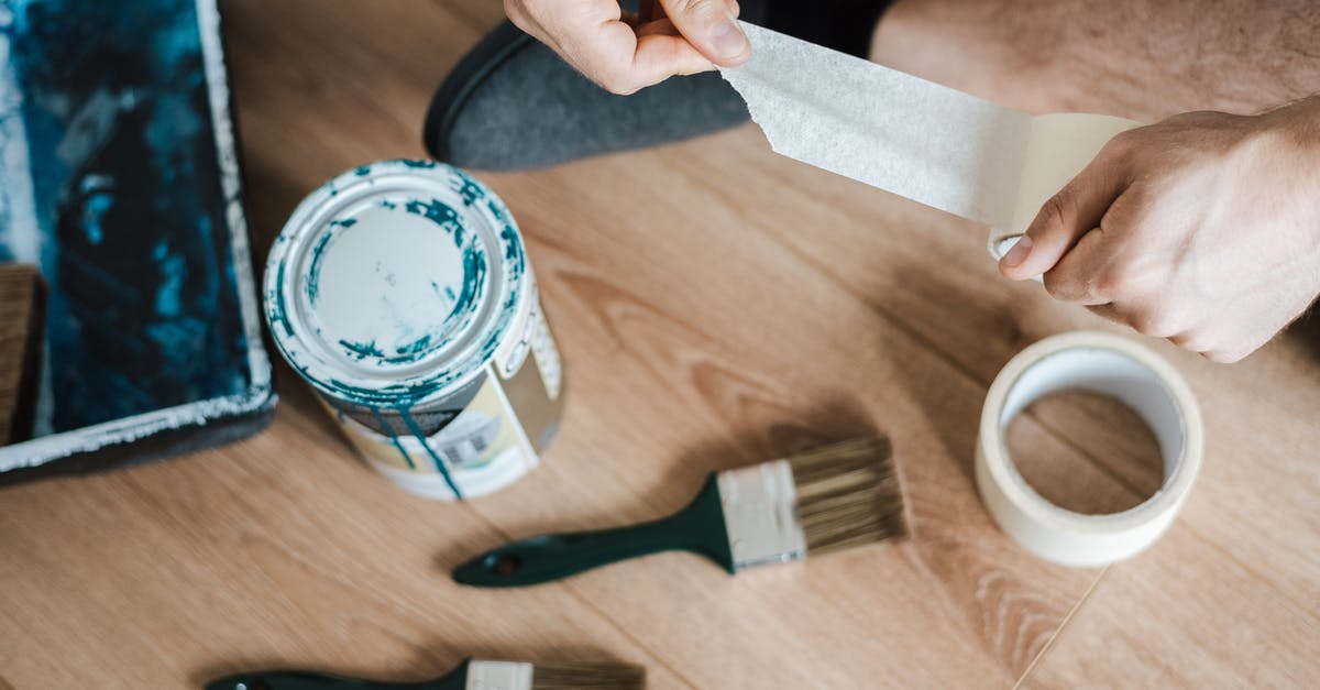 How can I make perfect sticky rice? - From above of crop anonymous male unwrapping sticky tape roll on parquet near paint brushes in house How can I make perfect sticky rice? - From above of crop anonymous male unwrapping sticky tape roll on parquet near paint brushes in house