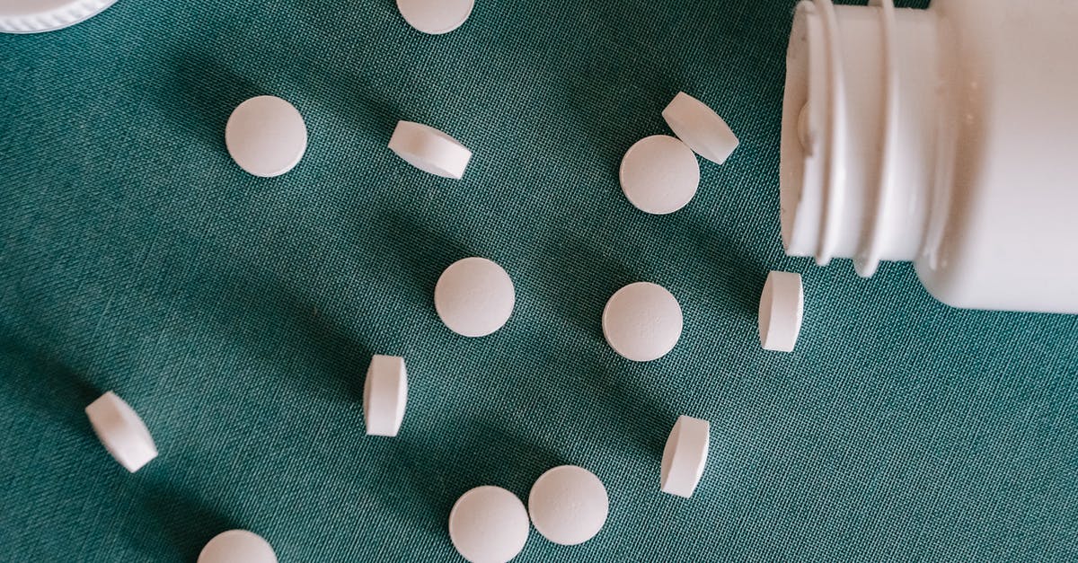 How can I measure / weigh really small quantities? - Top view of similar small round white pills spilled from plastic container on green surface How can I measure / weigh really small quantities? - Top view of similar small round white pills spilled from plastic container on green surface