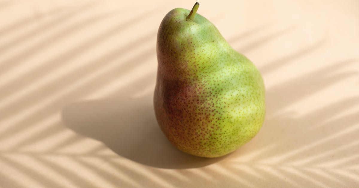How can I minimize stirring when blending whole fruits? - High angle composition of whole fresh healthy delicious pear located on white surface in sun shadow of palm stem How can I minimize stirring when blending whole fruits? - High angle composition of whole fresh healthy delicious pear located on white surface in sun shadow of palm stem