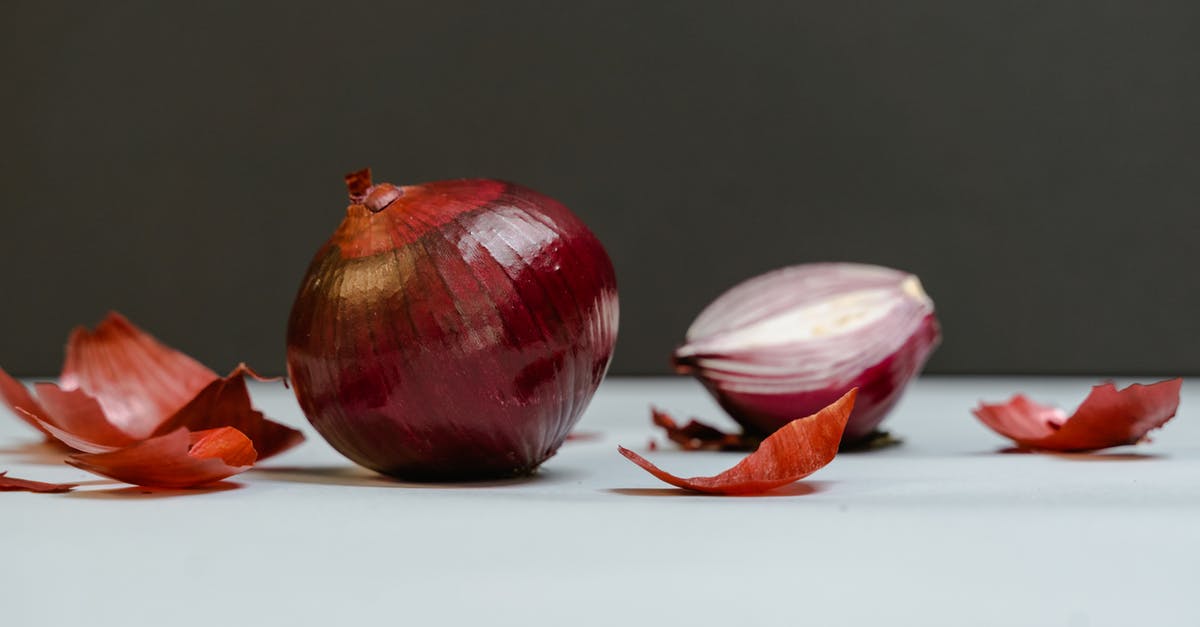 How can I peel pearl onions quickly? - Close-Up Shot of Onions on a White Surface How can I peel pearl onions quickly? - Close-Up Shot of Onions on a White Surface