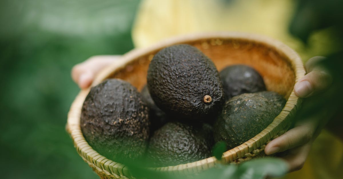 How can I pick the correct avocados for guacamole? [duplicate] - From above of crop anonymous person carrying wicker bowl full of fresh harvested avocados