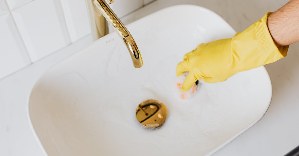 How can I prevent my sponge cake(genoise) from sinking after baking? [duplicate] - Person in glove using sponge with detergent for cleaning sink
