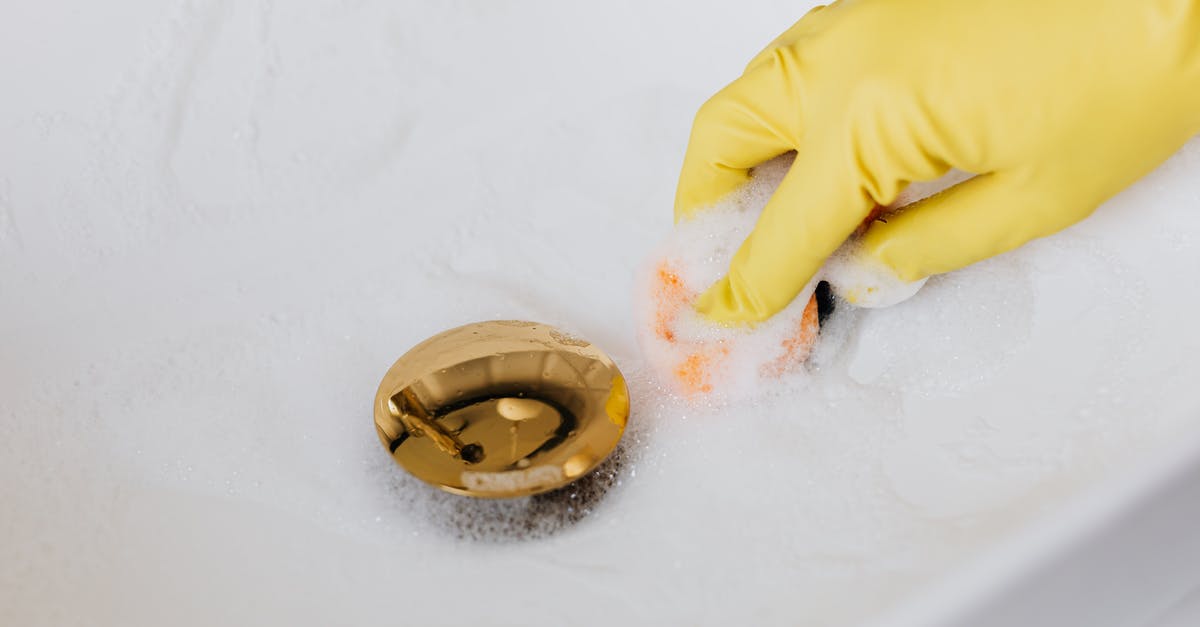 How can I prevent my sponge cake(genoise) from sinking after baking? [duplicate] - Person in glove using sponge and detergent for washing bathroom sink