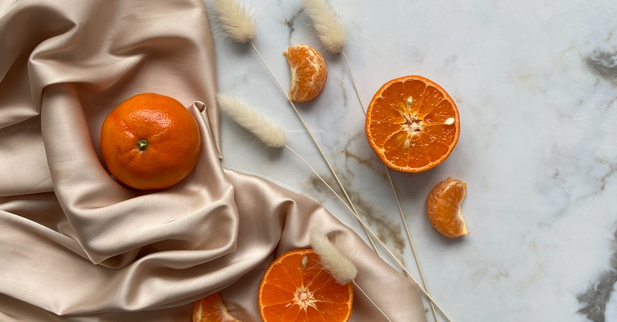 How can I rehydrate a dried navel orange? - Top view of fresh ripe slices of tangerine and oranges placed on crumpled fabric on marble surface with dried branches How can I rehydrate a dried navel orange? - Top view of fresh ripe slices of tangerine and oranges placed on crumpled fabric on marble surface with dried branches
