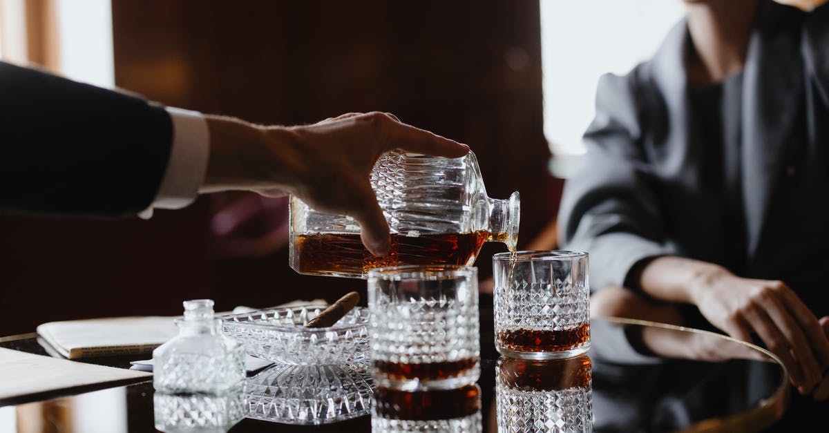How can I remove a stuck liquor decanter stopper? - A Person Pouring Drinks at a Table How can I remove a stuck liquor decanter stopper? - A Person Pouring Drinks at a Table
