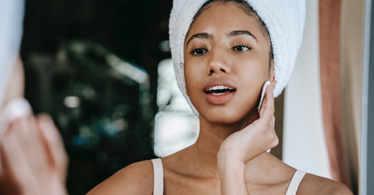 How can I remove moisture from my onions? - Ethnic female with mouth opened cleaning face with cotton pad while looking at mirror during daily beauty care How can I remove moisture from my onions? - Ethnic female with mouth opened cleaning face with cotton pad while looking at mirror during daily beauty care