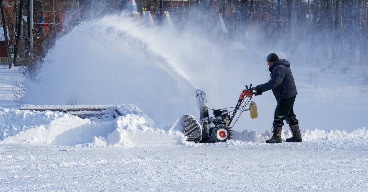 How can I remove the greasiness from my ice cream? - Full body man in warm clothes walking with snow thrower while cleaning yard in town How can I remove the greasiness from my ice cream? - Full body man in warm clothes walking with snow thrower while cleaning yard in town