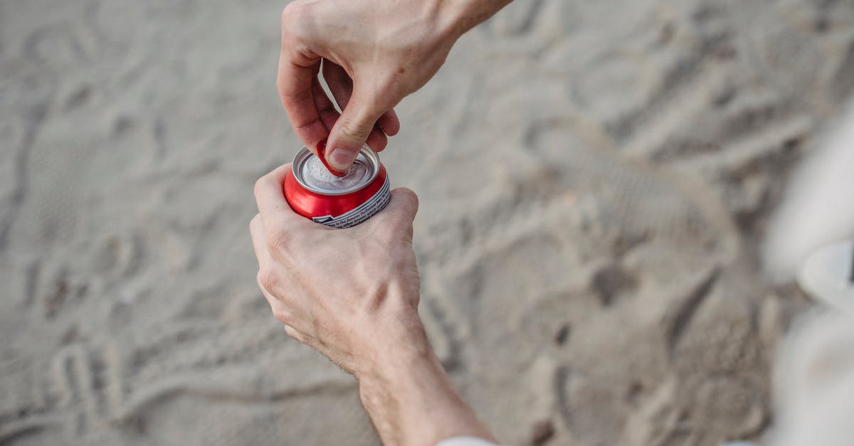 How can I restart my kombucha liquid? - From above of crop anonymous male opening can of drink standing on sandy beach How can I restart my kombucha liquid? - From above of crop anonymous male opening can of drink standing on sandy beach