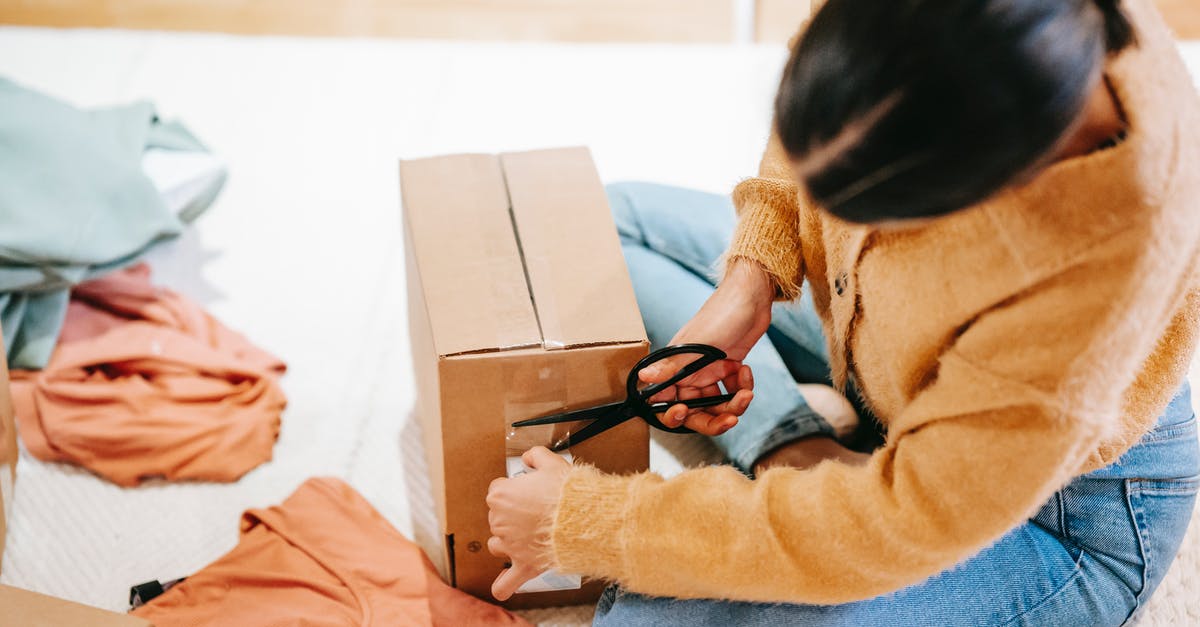 How can I safely improve my cutting technique - Woman cutting off adhesive tape from box with parcel