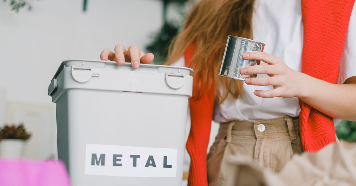 How can I save this vanilla extract? - Low angle of female putting tin can into bucket for metal trash for recycling litter How can I save this vanilla extract? - Low angle of female putting tin can into bucket for metal trash for recycling litter