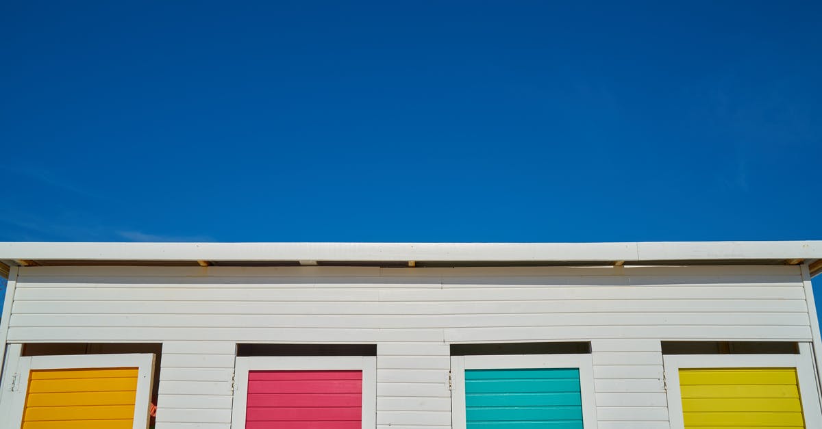 How can I tell whether a jackfruit has yellow or orange flesh by looking at the exterior of the jackfruit (i.e., without opening it)? - White Wooden House With Yellow, Pink, Green, and Orange Painted Windows