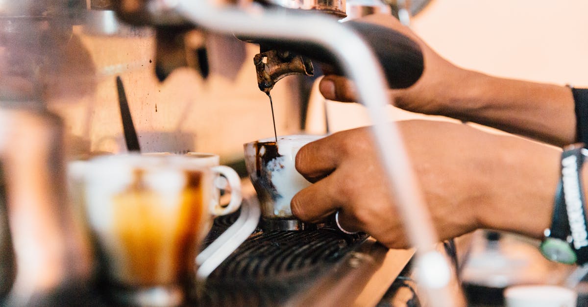 How can I thin out my ice cream mixture? - Faceless employee pouring coffee from machine in cafeteria How can I thin out my ice cream mixture? - Faceless employee pouring coffee from machine in cafeteria