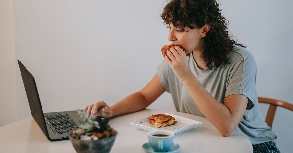 How can I toast rice without using an oven? - Young female with curly dark hair working with netbook while looking at screen and eating toasts with cup of coffee How can I toast rice without using an oven? - Young female with curly dark hair working with netbook while looking at screen and eating toasts with cup of coffee