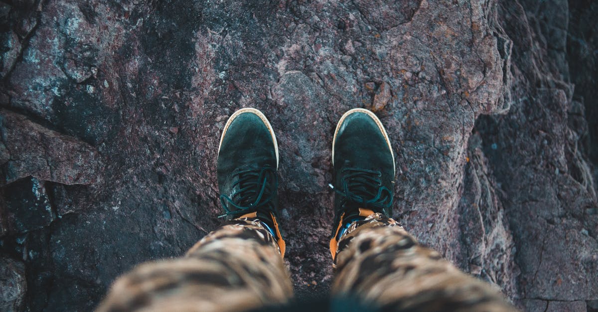 How can you achieve the glazed top in a mille-feuille? - From above of crop anonymous anonymous traveler in stylish sneakers standing on top of rough rocky cliff and admiring view How can you achieve the glazed top in a mille-feuille? - From above of crop anonymous anonymous traveler in stylish sneakers standing on top of rough rocky cliff and admiring view