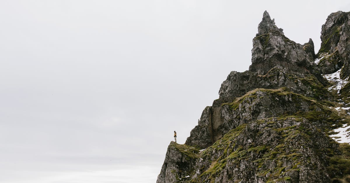 How can you achieve the glazed top in a mille-feuille? - From below of unrecognizable hiker standing alone on edge of rocky cliff against cloudy sky How can you achieve the glazed top in a mille-feuille? - From below of unrecognizable hiker standing alone on edge of rocky cliff against cloudy sky