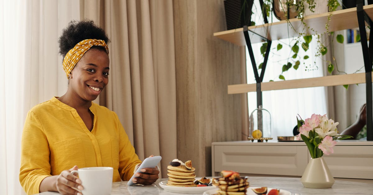 How can you keep a stack of Swedish pancakes fresh? - Woman in Yellow Long Sleeve Shirt Sitting on Chair in Front of Table With Foods How can you keep a stack of Swedish pancakes fresh? - Woman in Yellow Long Sleeve Shirt Sitting on Chair in Front of Table With Foods
