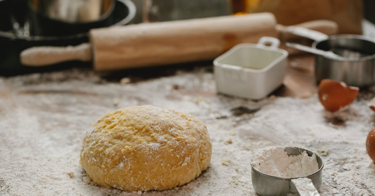 How can you make "All Purpose Flour" using home ground wheat? - Ball of raw dough placed on table sprinkled with flour near rolling pin dishware and measuring cup in kitchen on blurred background How can you make "All Purpose Flour" using home ground wheat? - Ball of raw dough placed on table sprinkled with flour near rolling pin dishware and measuring cup in kitchen on blurred background