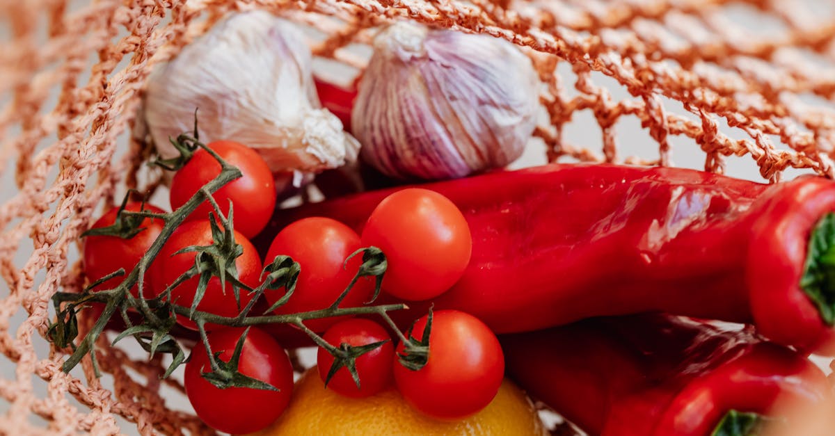 How can you reduce the heat of a chili pepper? - Assortment of fresh vegetables with lemon in food net How can you reduce the heat of a chili pepper? - Assortment of fresh vegetables with lemon in food net