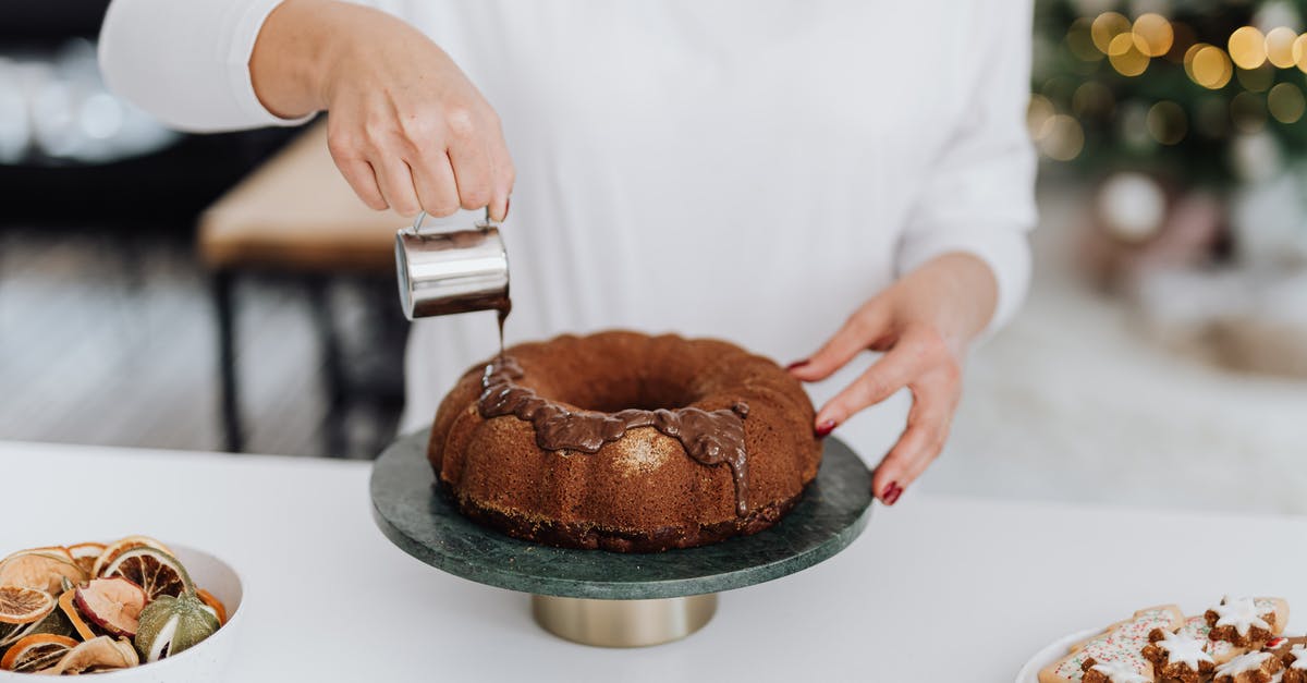 How can you speed up a genoise cake mixing? - Person in White Dress Shirt Holding Brown Round Cake How can you speed up a genoise cake mixing? - Person in White Dress Shirt Holding Brown Round Cake