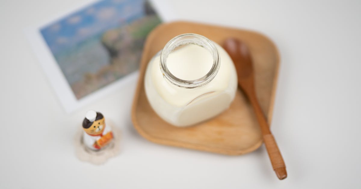How can you thicken lactose free cream - From above arrangement of fresh milk yogurt in glass jar placed on wooden saucer near funny cat figurine and blurred photo of nature How can you thicken lactose free cream - From above arrangement of fresh milk yogurt in glass jar placed on wooden saucer near funny cat figurine and blurred photo of nature