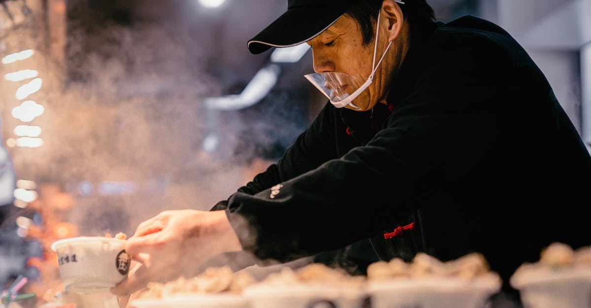How could I cook industry like foie gras? - Man in Black Jacket and Black Hat Holding White Plastic Cups With Food How could I cook industry like foie gras? - Man in Black Jacket and Black Hat Holding White Plastic Cups With Food
