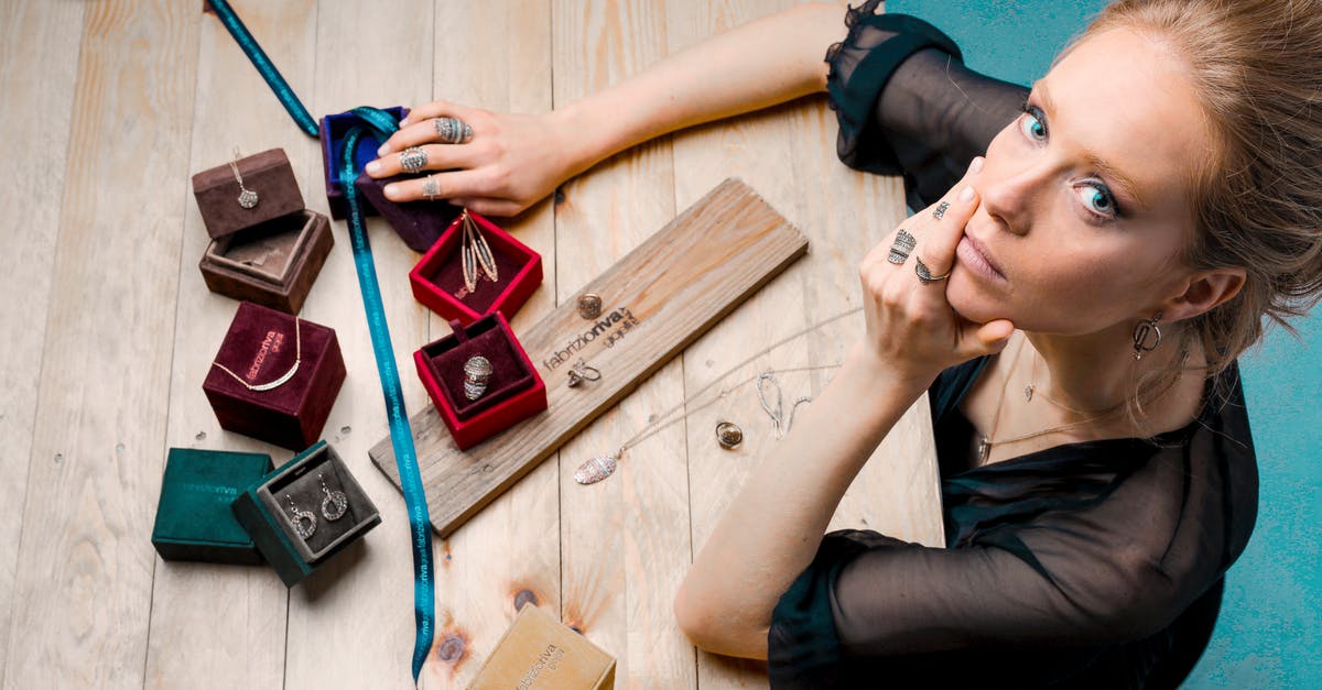 How did I strip the patina off my wok? - From above serious businesswoman looking up at camera while sitting at wooden table with small jewelry boxes with bijouterie and decorating with ribbon as present How did I strip the patina off my wok? - From above serious businesswoman looking up at camera while sitting at wooden table with small jewelry boxes with bijouterie and decorating with ribbon as present