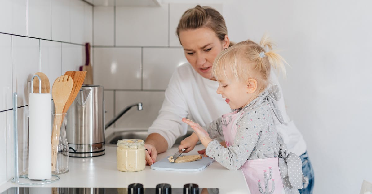 How do cooking utensils remain safe for use? - Woman in White Sweater Looking at a Girl in Apron Holding Knife How do cooking utensils remain safe for use? - Woman in White Sweater Looking at a Girl in Apron Holding Knife