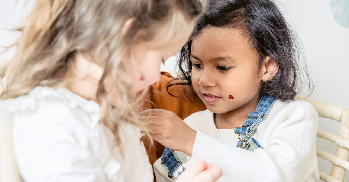 How do egg whites help to keep fats inside a cake? - Focused diverse girls playing with stickers during Easter celebration How do egg whites help to keep fats inside a cake? - Focused diverse girls playing with stickers during Easter celebration