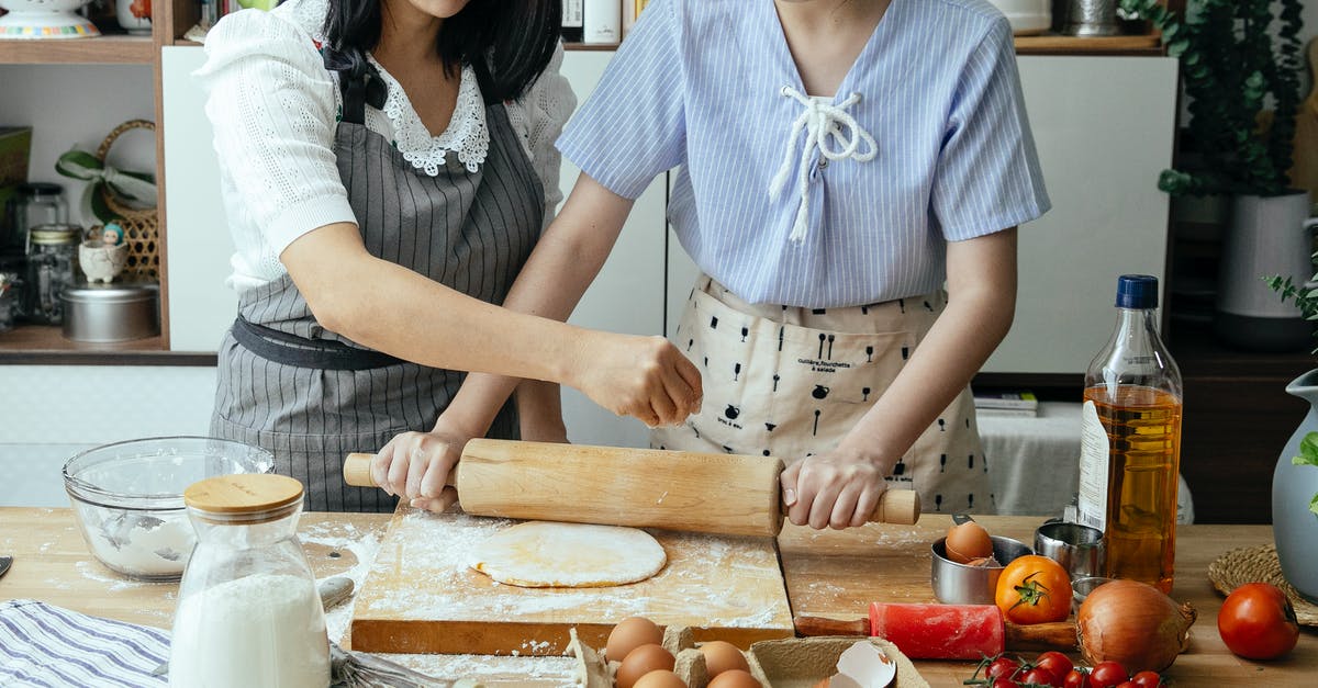 How do egg whites help to keep fats inside a cake? - Crop anonymous mother standing near table with daughter while cooking in aprons with flour and eggs while rolling pastry at home How do egg whites help to keep fats inside a cake? - Crop anonymous mother standing near table with daughter while cooking in aprons with flour and eggs while rolling pastry at home