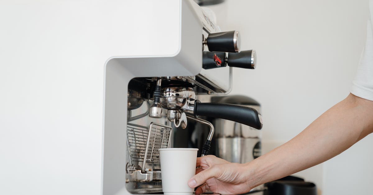How do espresso machines hold pressure at all? - Person Holding White Cup How do espresso machines hold pressure at all? - Person Holding White Cup