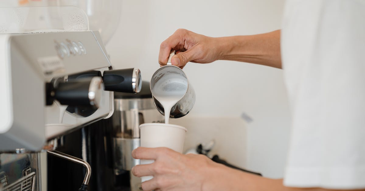 How do espresso machines hold pressure at all? - Person Pouring Milk on White Cup How do espresso machines hold pressure at all? - Person Pouring Milk on White Cup