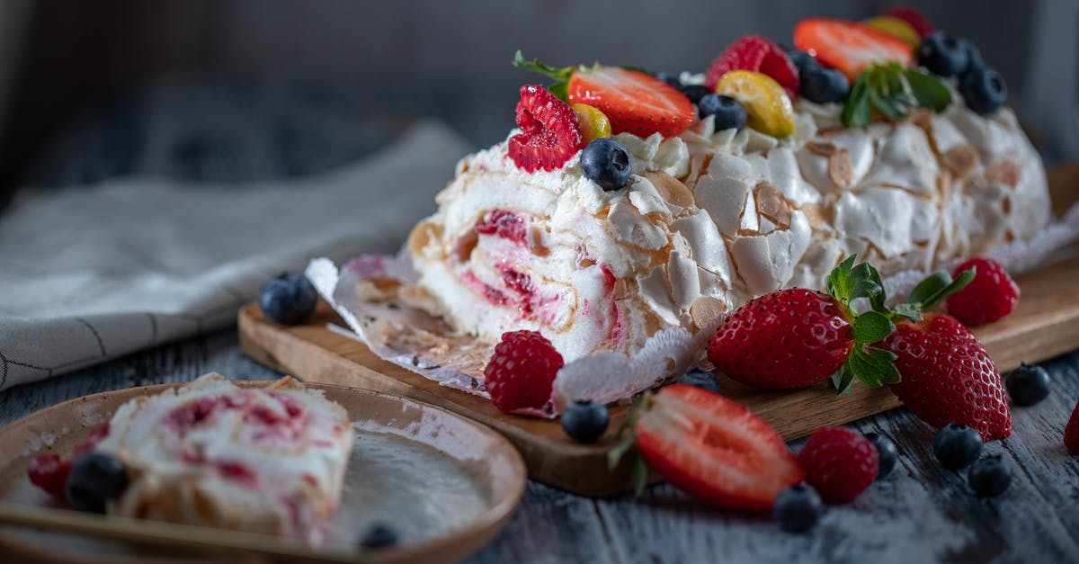 How do I add a strawberry swirl to my cheesecake without cracks and craters? - Tasty sweet meringue roll garnished with fresh berry mix and tender cream served on wooden board and plate How do I add a strawberry swirl to my cheesecake without cracks and craters? - Tasty sweet meringue roll garnished with fresh berry mix and tender cream served on wooden board and plate